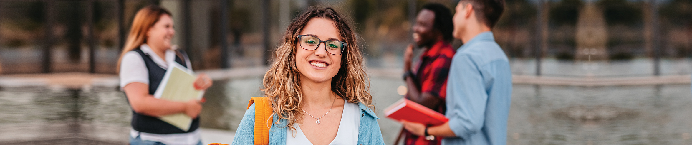 girl smiling holding a book